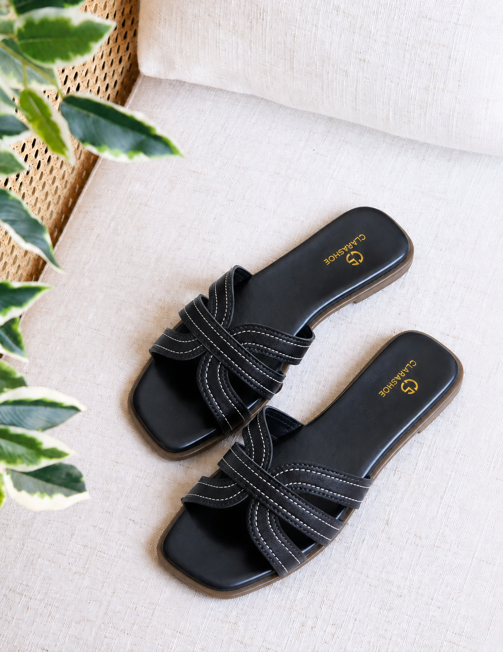 Black criss-cross flat slide sandal with contrast stitching by Clarashoe