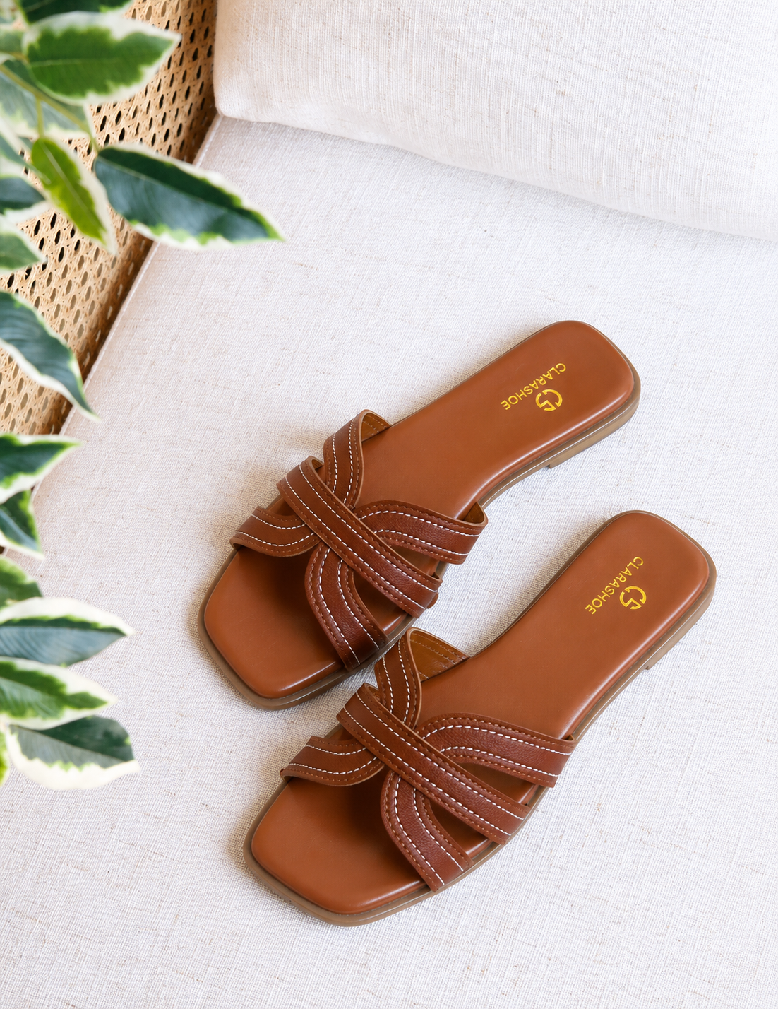 Black criss-cross flat slide sandal with contrast stitching by Clarashoe